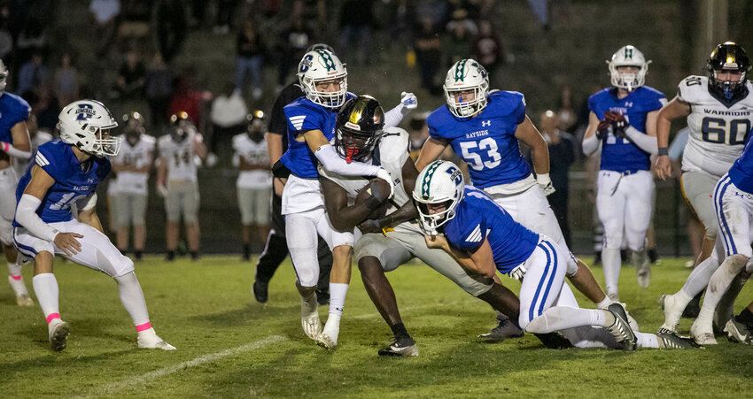 The Bayside Academy defense, including sophomore Sam Cunningham (10), senior Kelan Stacey (15), sophomore Ladd Powers (11) and junior Noah Breeland (53), rally for a stop of Cottage Hill junior Shadarius Toodle, an Auburn commit, during the first half of the Class 3A Region 1 game between the Admirals and Warriors at Freedom Field in Daphne on Friday, Oct. 11. Bayside Academy kept Cottage Hill off the scoreboard until the final 1:23 of regulation to secure a 27-7 win that kept the Admirals undefeated in region play.