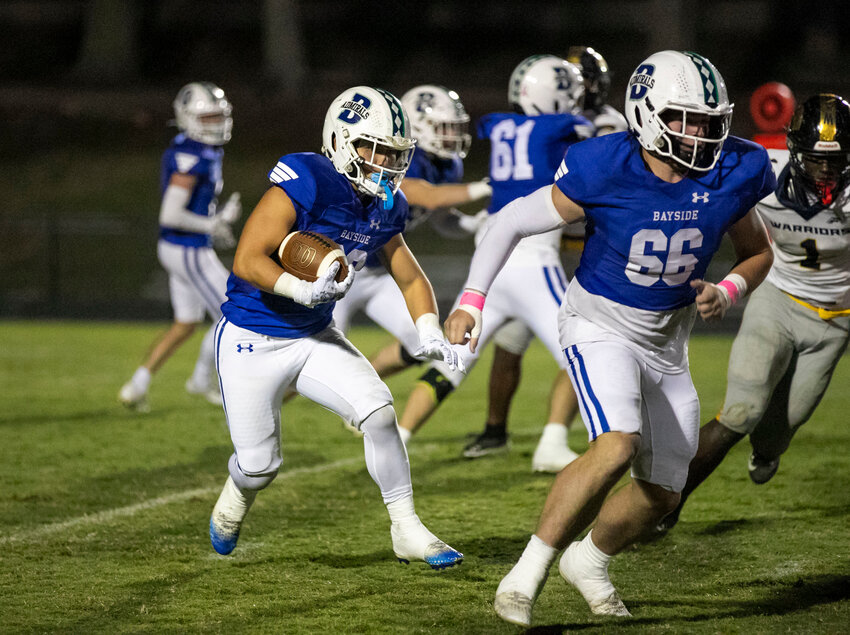 Bayside Academy junior Brennen Yamane looks for running room on the outside behind the blocking of classmate Will Allen during the Admirals&rsquo; Class 3A Region 1 contest against the Cottage Hill Christian Warriors on Friday, Oct. 11, at Freedom Field in Daphne. It served as Yamane&rsquo;s first game back with his hometown team after he spent his sophomore season at IMG Academy in Florida then suffered an injury at the beginning of the regular season.