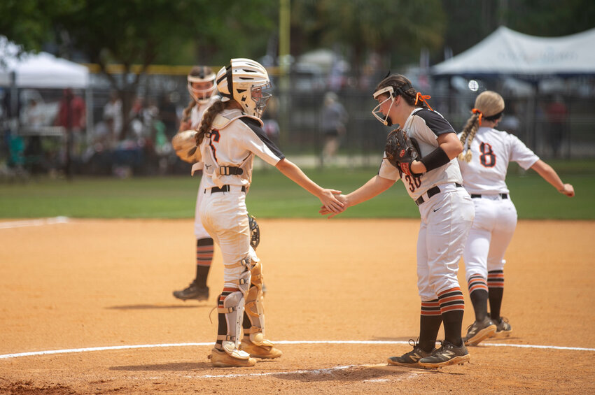 Madilyn Byrd and Ryann Wallace share a high five before returning to action for the Baldwin County Tigers during the AHSAA South Regional Championships in Gulf Shores on May 7, 2024. The pitcher-catcher battery was on display this weekend as Byrd, a senior Florida Atlantic signee, produced her 1,000th career strikeout.