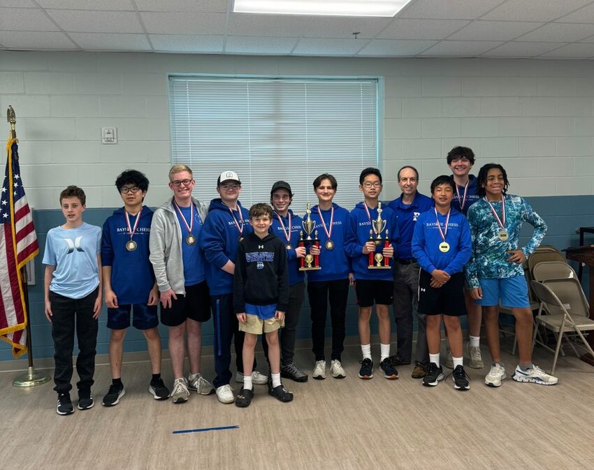 Pictured from left to right are Burke Ramagosa, Huan Chen, Colt Hancock, Evan Stafford, Ben Freeman, Jacob Stallworth, John Stephen Klimjack, Don Chen, Bayside Academy Chess Coach Paul Nager, Jeremy Ou, Boyce Magli and Elias Blossom.