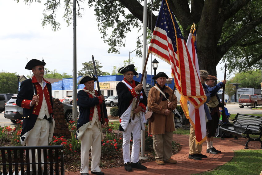 After the prayer, the SAR color guard lined up and marched towards the Veteran's Memorial flagpole at the Foley Centennial Park to raise a 13-star American flag.