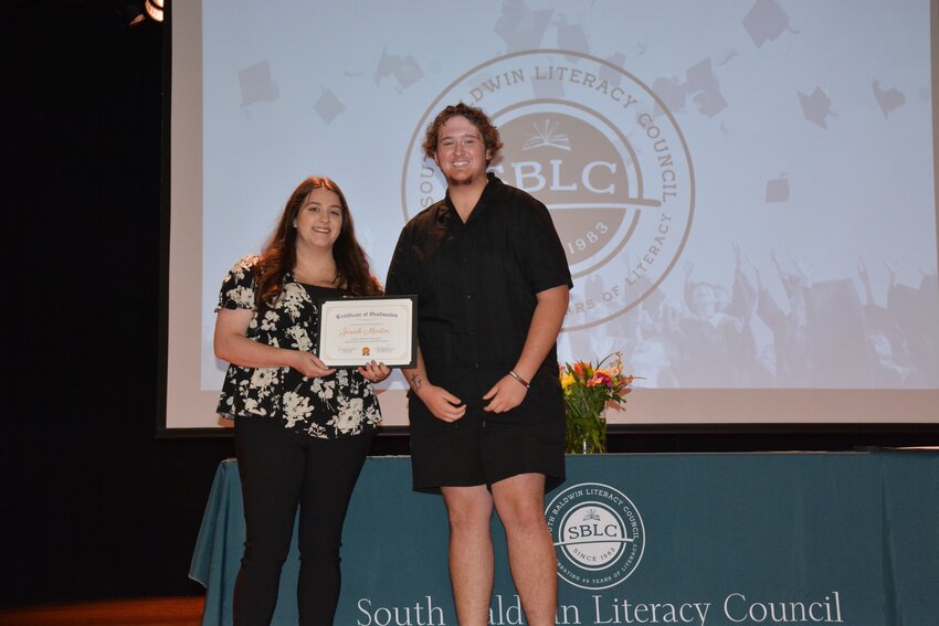 SBLC staff member and GED program graduate, Timberlynn Belcher, pose with her certificate of completion.