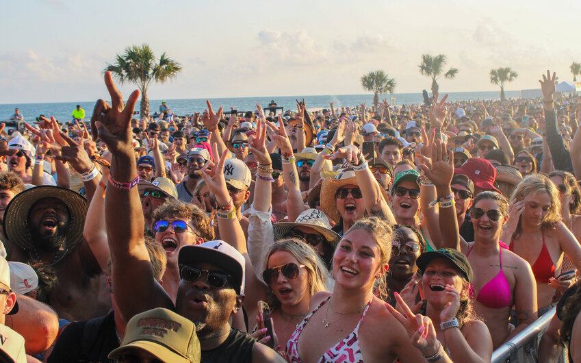 A crowd cheers at Sand in My Boots Festival 2025.