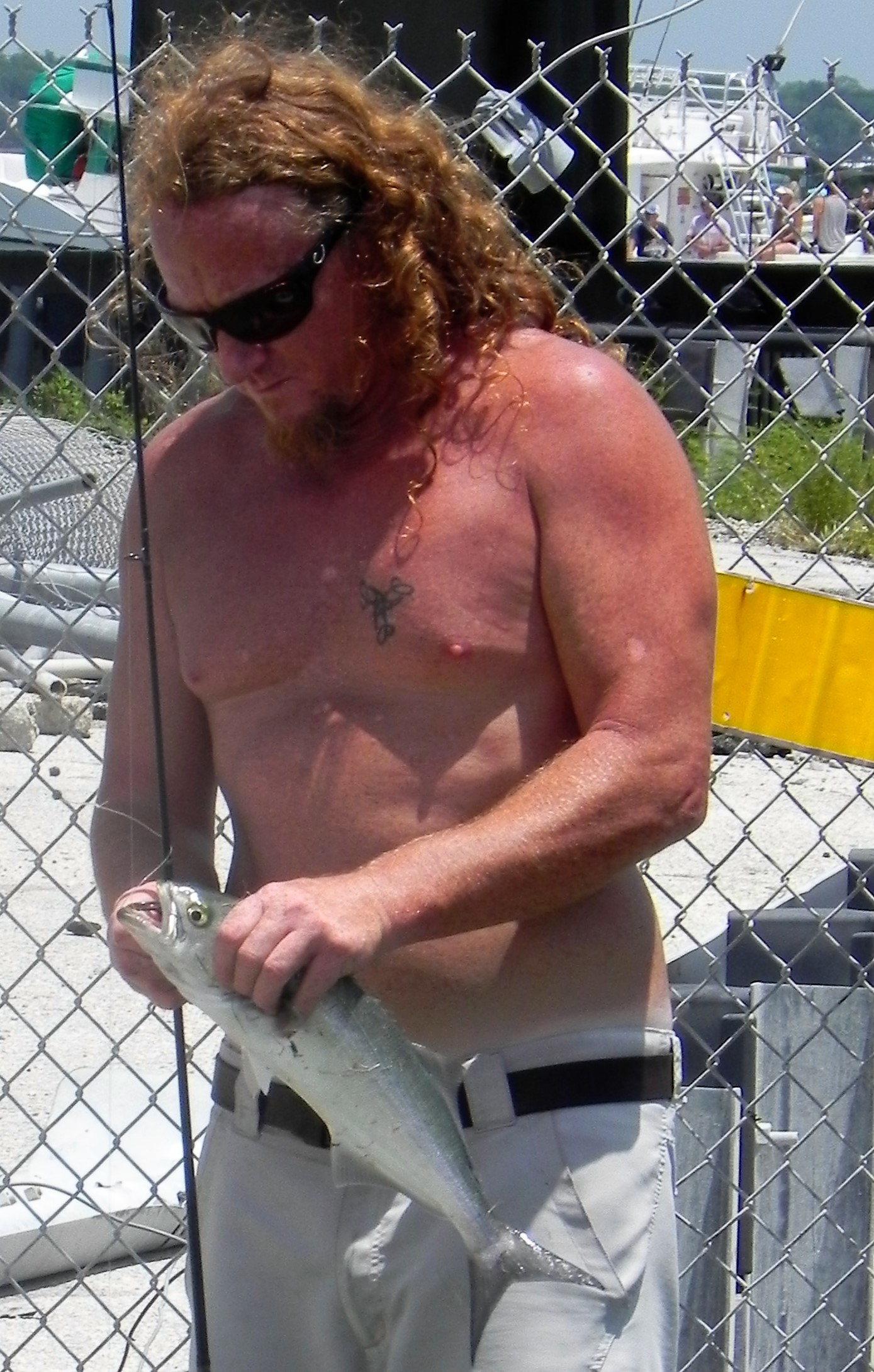 Jeremy Slaughter of Summerdale shows off a bluefish he caught in Perdido Pass.