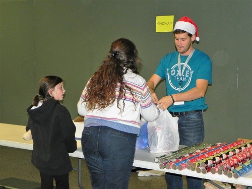 Loxley Church of God volunteer Blake Wolfe checks out residents during Saturday’s Big Give program at the church.
