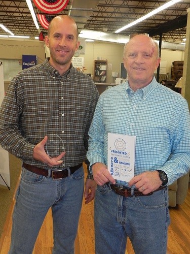 Joe Kitchens, right, and son Jonathan of Furniture City display their award as a finalist for the 2016 Alabama Small Business of the Year (one to 10 employees).