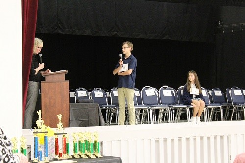 Fletcher Ard closes out the 2017 Spelling Bee with pronouncer Dr. Joyce Woodburn, academic dean for Baldwin County Public Schools, giving him the final word of the competition, as runner up Kate Ginger of Bayside Academy looks on.