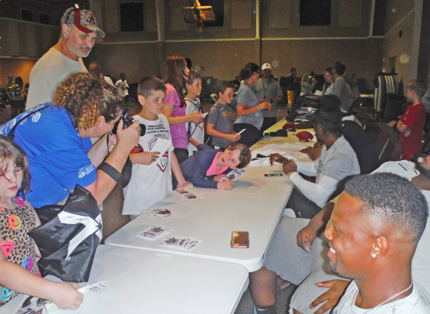 Meeting Cincinnati Bengals cornerback Torren McGaster and other players at Trojan Hall for autographs.