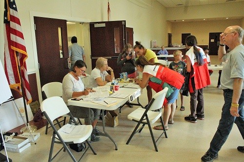 Volunteers from the American Red Cross sign in evacuees at the Baldwin County Coliseum on Sunday.