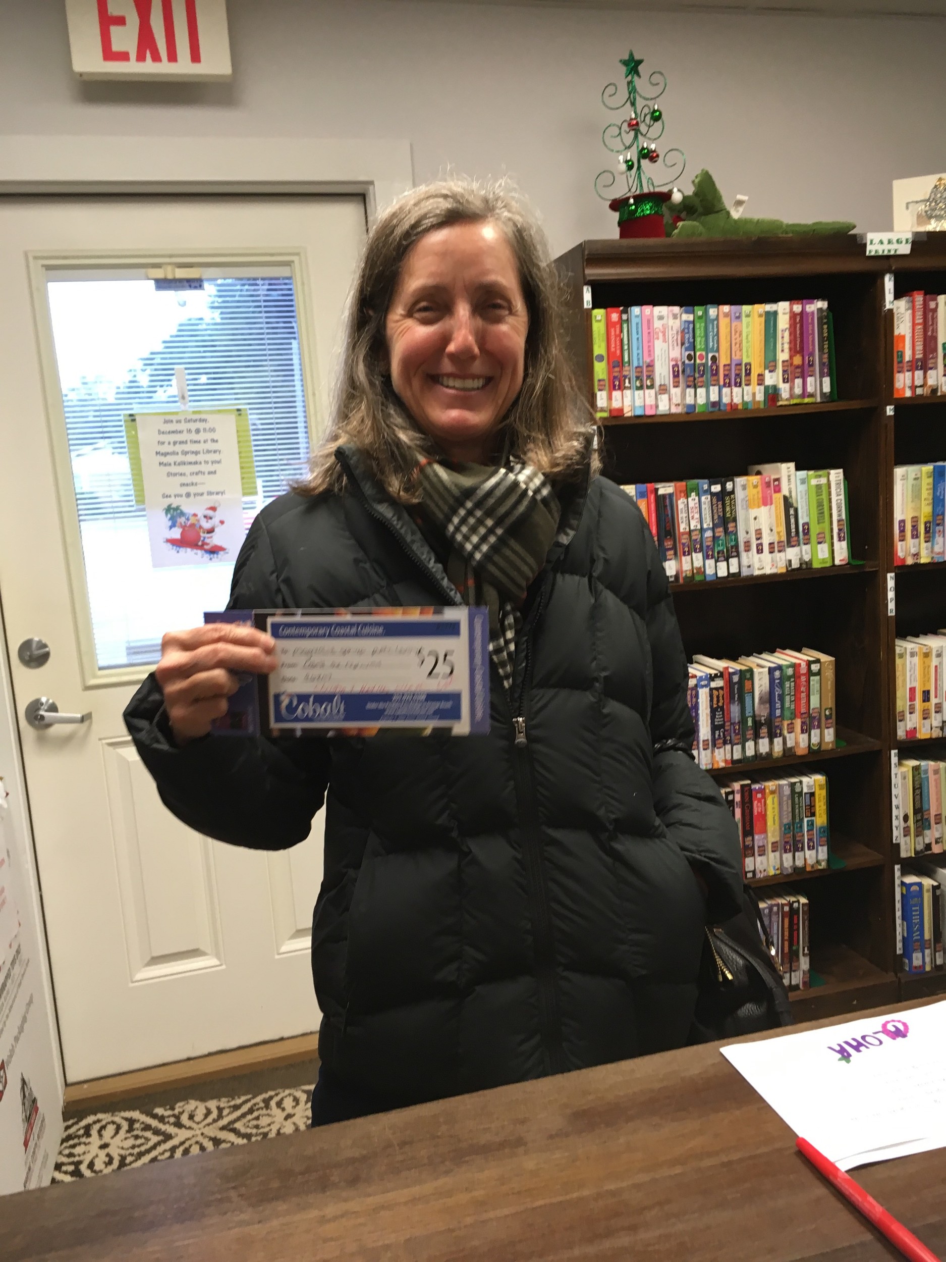 Proud supporter of The Magnolia Springs Library Kristin Weaver with her gift certificate to Cobalt’s Restaurant.