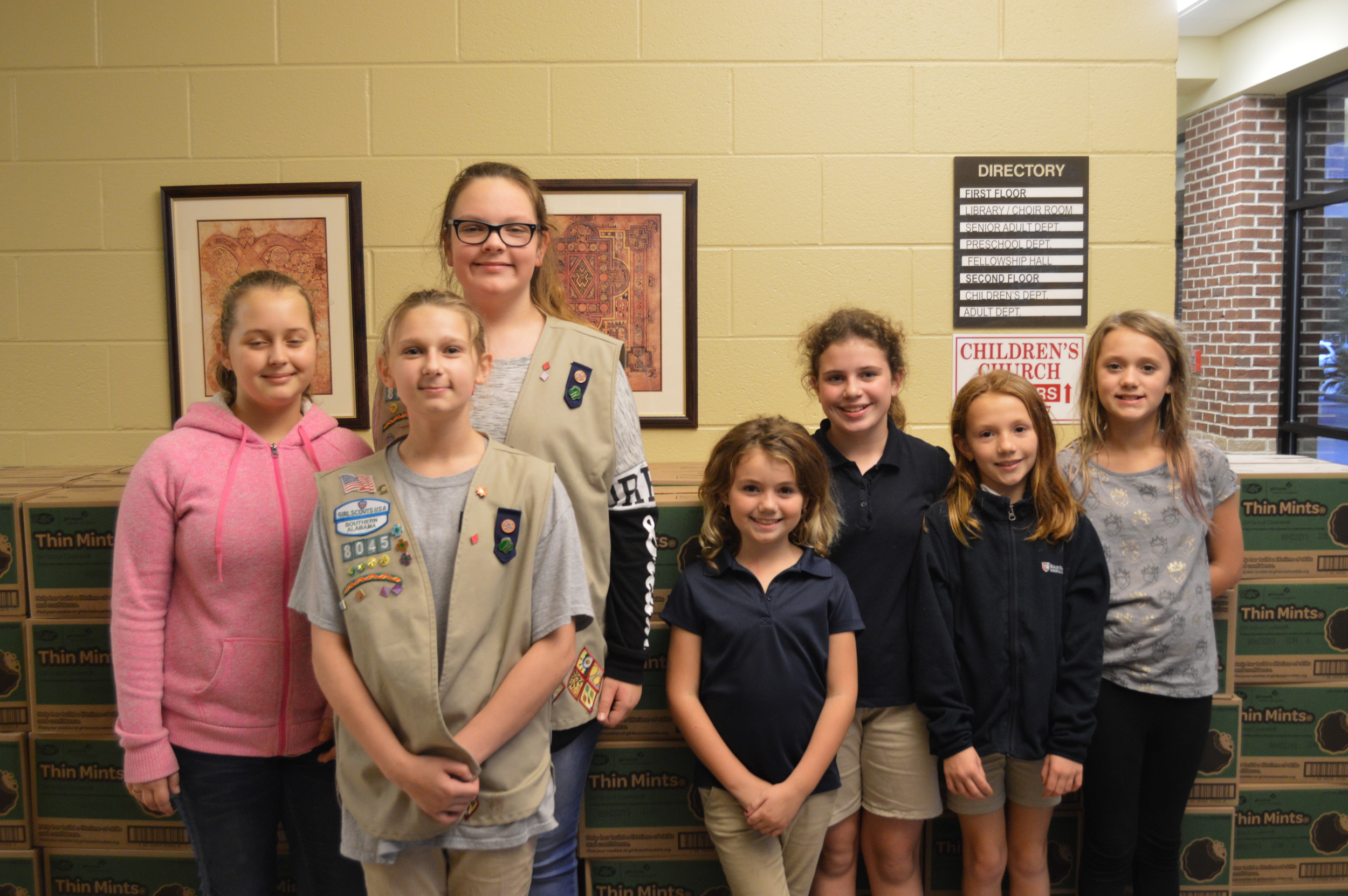 Girl Scouts from the Foley troop help unload cookie boxes from the delivery truck, and are ready to begin selling in their community.