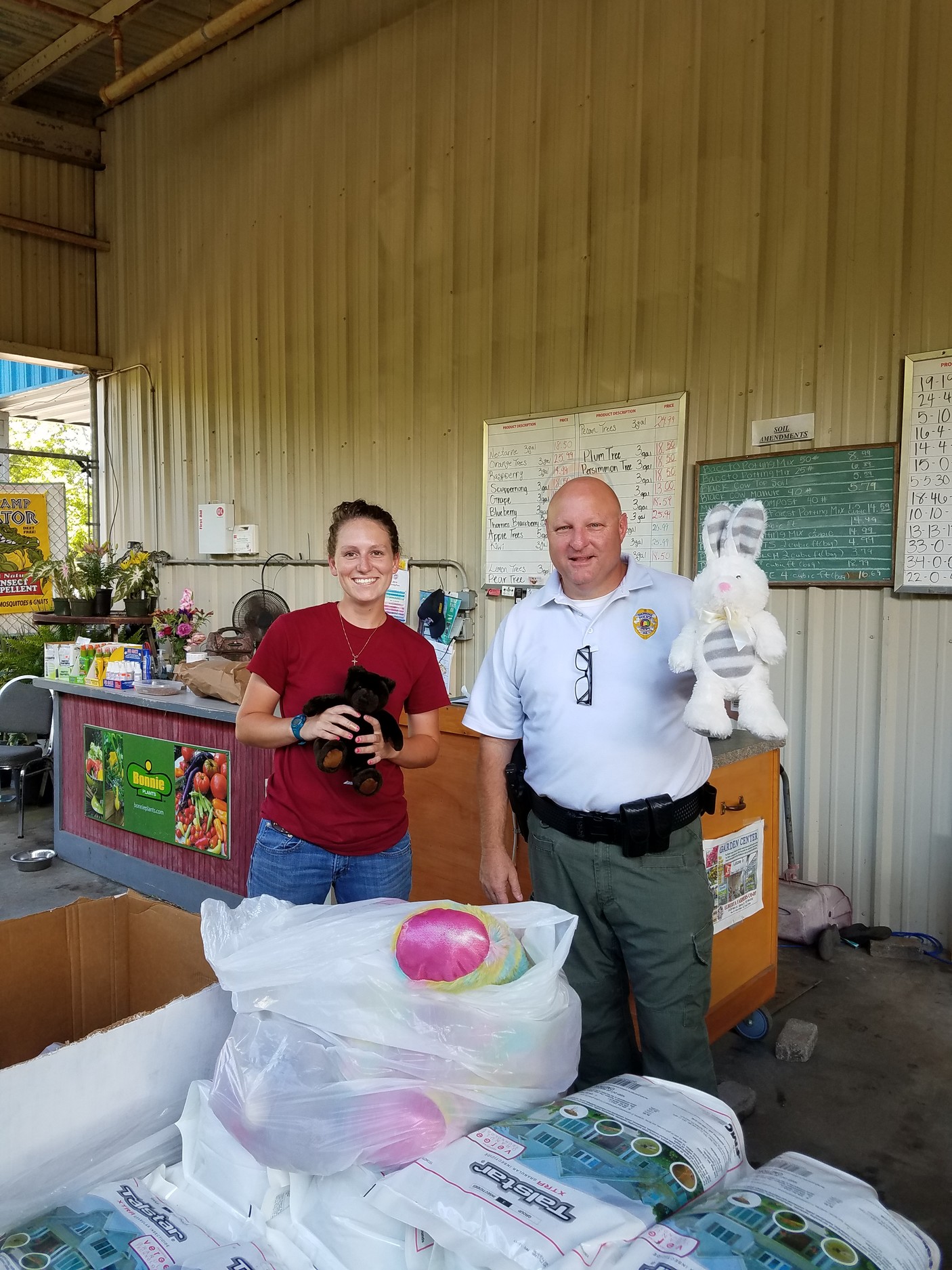 Elberta Farmers Co-Op employee Kristen Edwards and Daphne Sergeant Ken Lassiter, on the morning of May 16, when Lassiter dropped by to pick up donated stuffed animals for the police department.