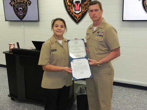 Cadet Seaman Apprentice Sierra Seladones receives the Meritorious Achievement Ribbon from Lt. Commander Frank Starr, senior Naval Junior ROTC instructor at Robertsdale High School.
