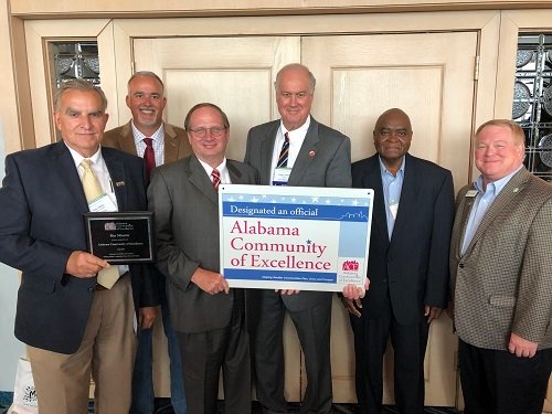 Bay Minette Mayor Bob Wills, third from right, was recognized on behalf of the city as part of the 2019 incoming class of the Alabama Communities of Excellence at the Alabama League of Municipalities convention May 4 in Mobile.