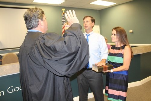 Jared Lyles, with wife Christie, is sworn in May 20 as Silverhill mayor by Municipal Court Judge Ken Raines.