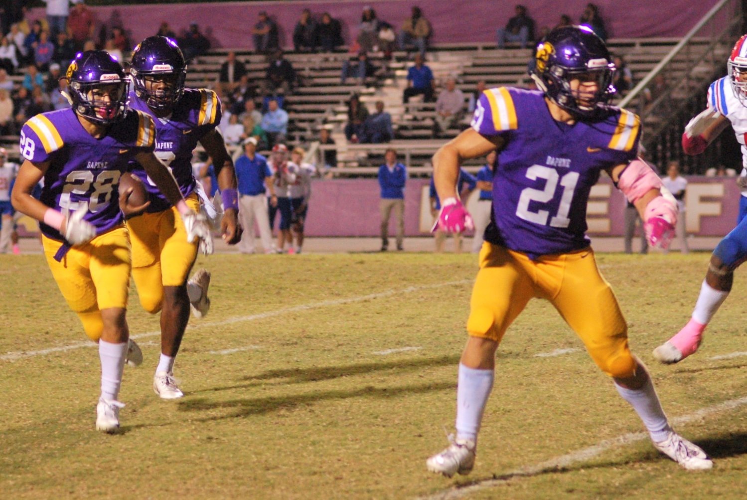 Daphne junior Trent Battle gets lead blocking from Veontai Williams (28) and Davis Oliver (21) during the Trojans’ Class 6A Region 1 game against St. Paul’s Episcopal at Jubilee Stadium Oct. 24, 2019. Now a full-time running back for the TCU Horned Frogs, Battle will have a chance to become the third former Trojan to play in the national championship game in the last 10 years.