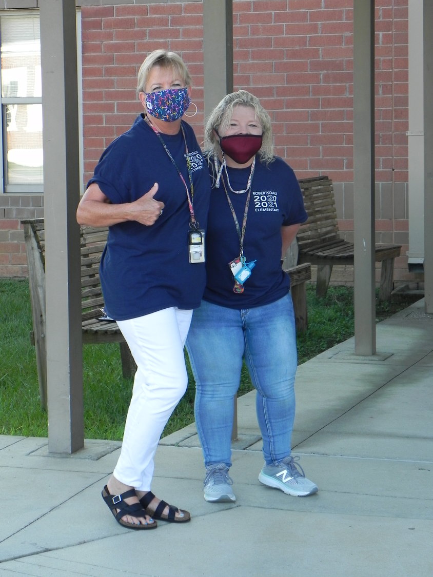 “We’re smiling, really!” Faculty members at Robertsdale Elementary School greeted students on the first day of school Wednesday.