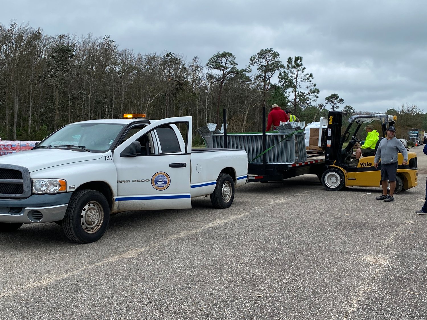 Crews at the POD loading a trailer with pallets of ice, boxes of bleach and gallons of gasoline to transport to Bear Point.
