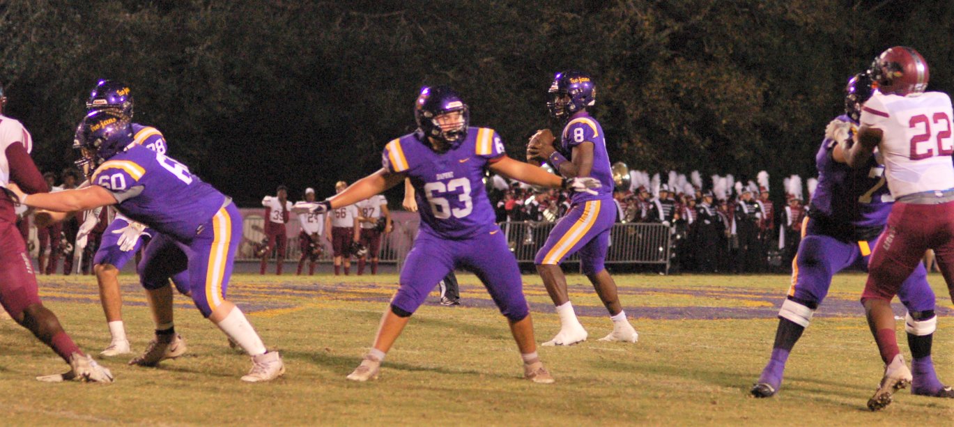 The Trojan offensive line gives quarterback Trent Battle time to scan the field on a pass attempt in the first round of the Class 7A playoffs Nov. 6, 2020, against Prattville at Jubilee Stadium in Daphne. In his transition to the college ranks, Battle has moved to be a running back and special teamer for the TCU Horned Frogs.