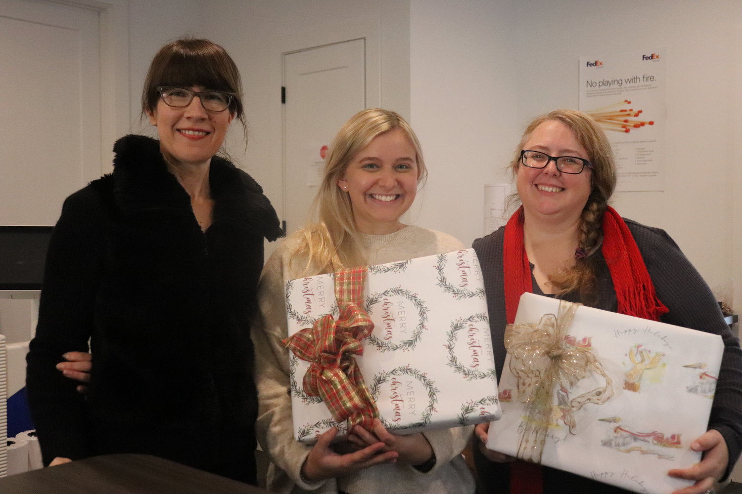 Julie Comer, Grace Horne and Jamie Hadden craft custom gift wrapping for artists and families.