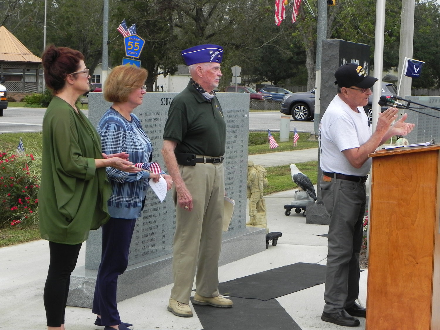 Frankie Kucera, president of the Silverhill Veterans Memorial Organization, congratulates Ed Evans, along with his daughters, Karla Dauzat and Marcia Evans, who nominated him for the award.