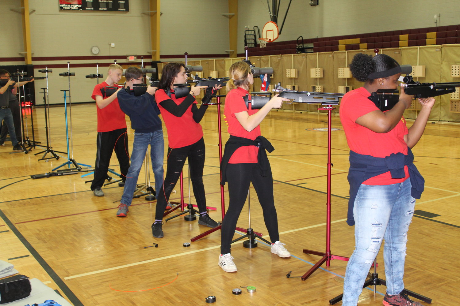 Members of the Robertsdale High School NJROTC air rifle team participate in a competition held last February in the gym at Robertsdale High School.