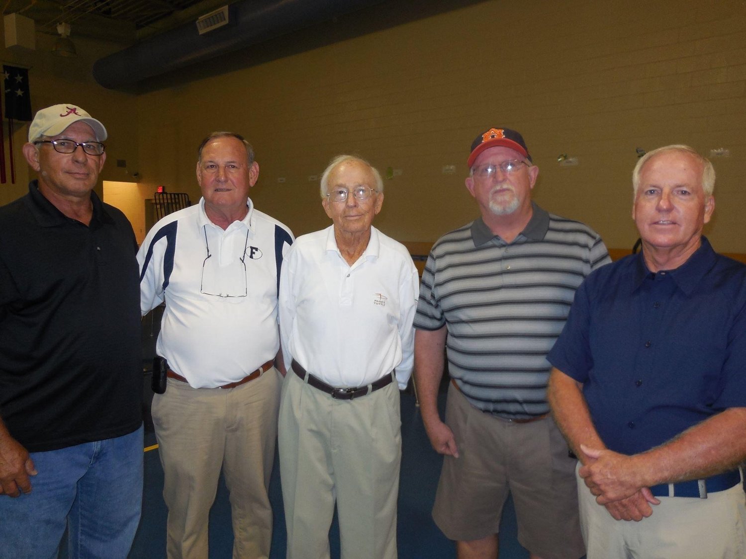Coach Ivan Jones, flanked by players from the 1968 football team, from left, Savelle Rasbury, Denny Price, Jones, Alan Blackwell and Mike Smith.