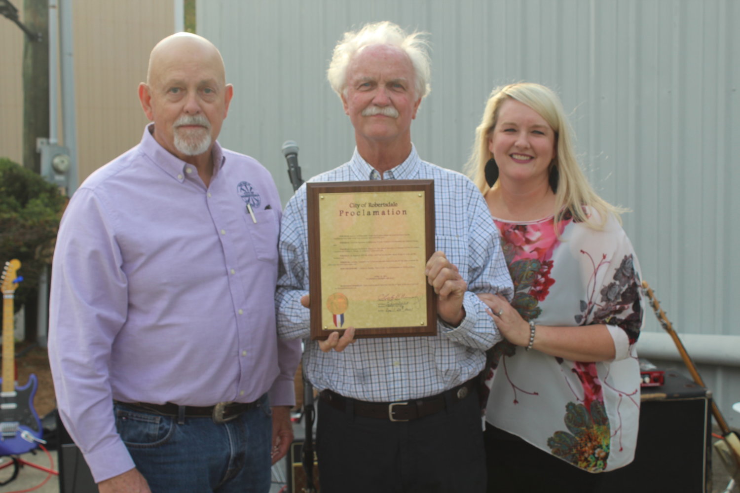 Nelson Wingo and daughter Ashley Kucera receive a proclamation from Robertsdale Mayor Charles Murphy.