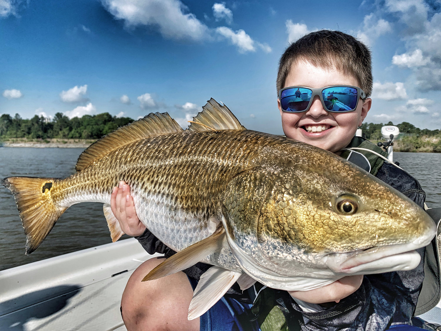 Hayden Turner shows off a beautiful redfish that was tagged during a trip with Capt. Patric Garmeson.
