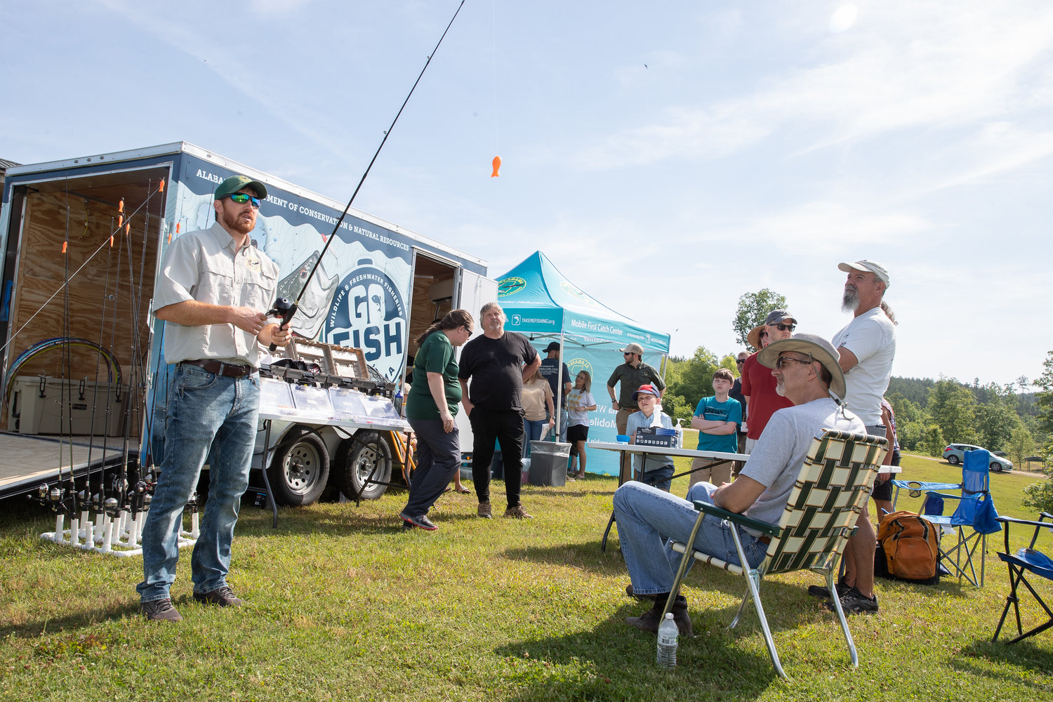 Nathan Aycock of the Alabama Wildlife and Freshwater Fisheries Division demonstrates casting techniques to attendees at the Go Fish, Alabama! event at Bibb County Lake.