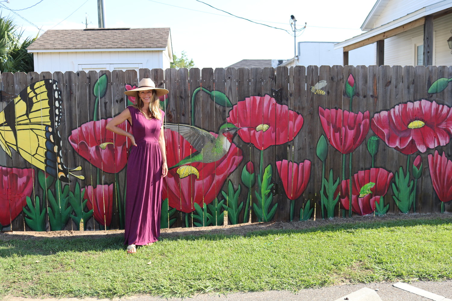 Artist Jessica Kinsey stands before her completed mural.