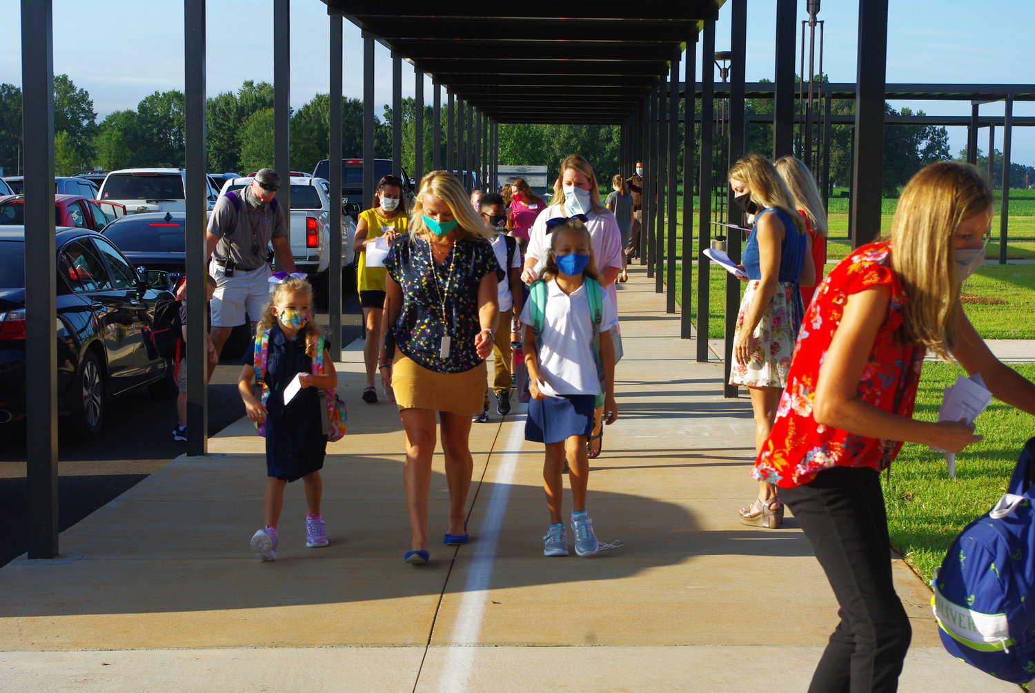 Students wearing masks arrive for the first day of the 2020-21 school year. Baldwin County public schools will again require masks when the 2021-22 academic year starts Aug. 11.