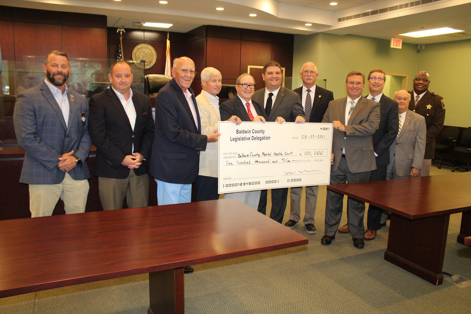 Members of the Baldwin County Legislative Delegation present a check for $100,000 on Tuesday, Aug. 3 to establish a Mental Health Court in Baldwin County. Pictured are, from left, Baldwin County Commissioner Jeb Ball, Sen. Chris Elliott, Rep. Harry Shiver, Rep. Alan Baker, Rep. Steve McMillan, Rep. Matt Simpson, District Attorney Bob Wilters, Judge Scott Taylor, Judge Jody Bishop, Judge Harry D’Olive and Maj. Jimmy Milton with the Baldwin County Sheriff’s Office.