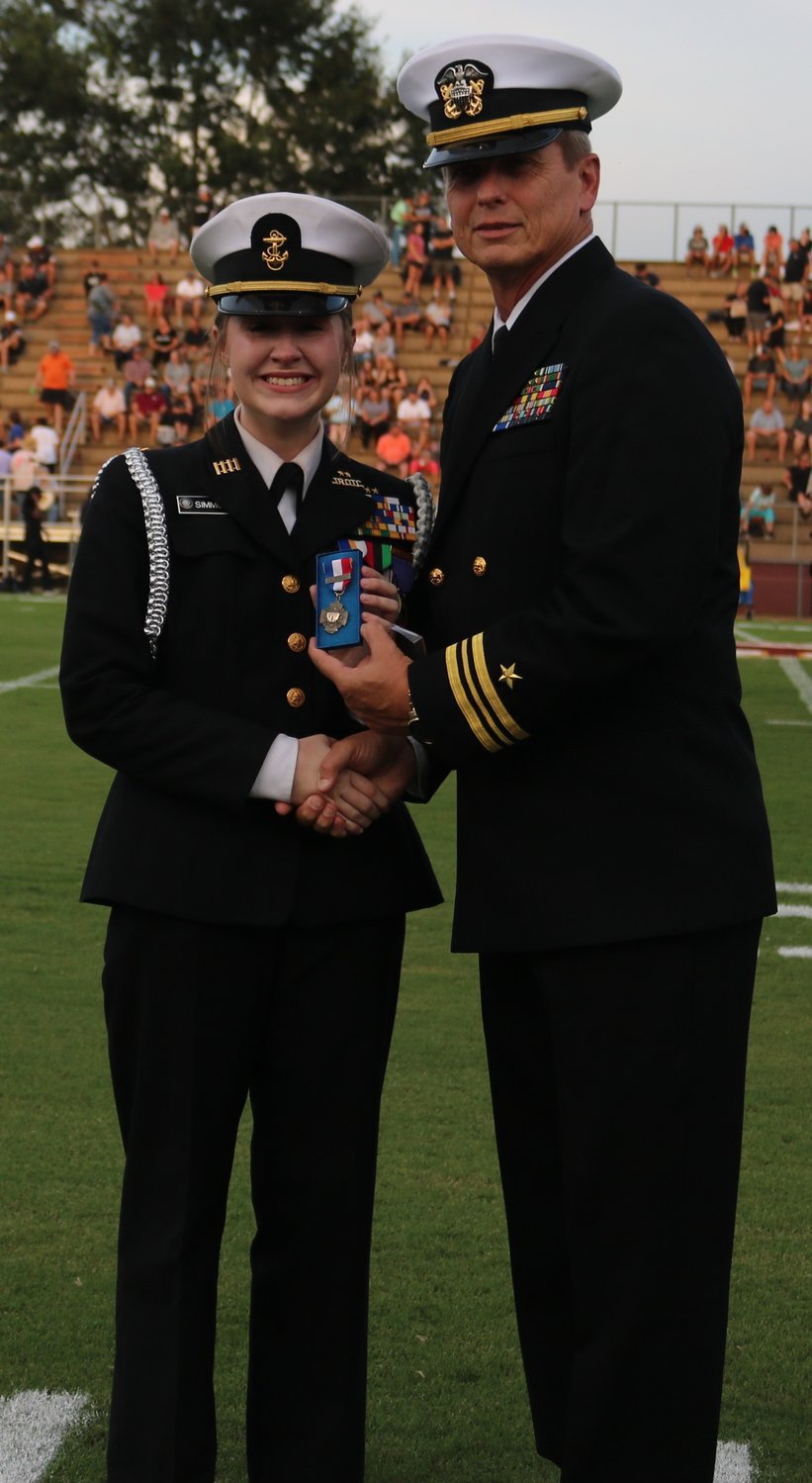 RHS NJROTC Commander Frank Starr presents Cadet Ashlynn Simmons with her award.