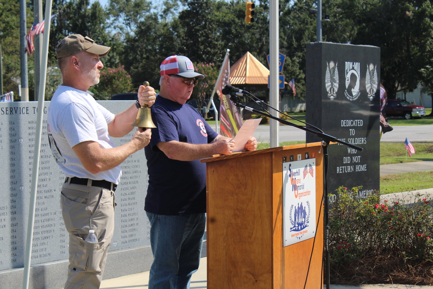 Silverhill Veterans Memorial Organization member Joel Sterling rings a bell as Vice President Danny Murphy reads the names of 13 soldiers killed Thursday, Aug. 26 in Afghanistan.