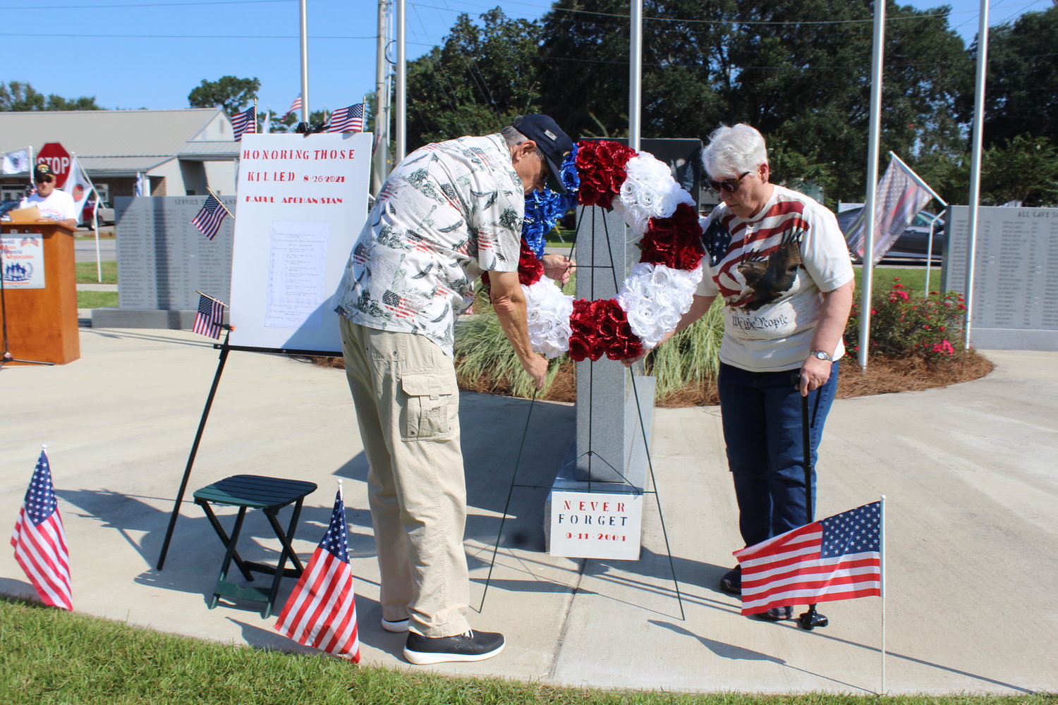 Pat and Pat Burke, members of the Silverhill Veterans Memorial Organization, place a wreath honoring and remembering the 13 soldiers who were killed on Thursday, Aug. 26 in Kabul, Afghanistan.