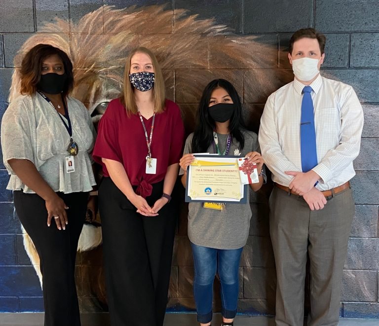 Foley Middle School student Brenda Laurin Garcia Monroy (holding certificate) is pictured with (l-r) Assistant Principal Tiara Bailey, teacher Stephanie Whiddon and WALA FOX 10 TV’s meteorologist Michael White.