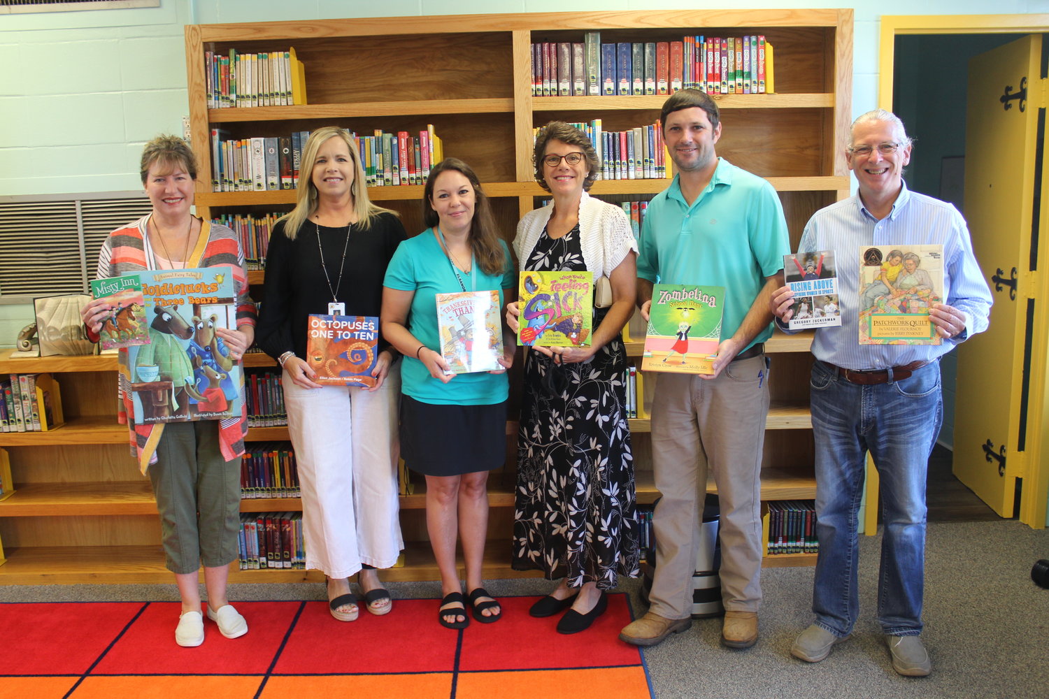 The Robertsdale Rotary Club and Dickerson Literacy Initiatives came together to make a donation of 65 books recently to Elsanor School library media specialist Susan Loy and Principal Charlotte Gray. The donation represents about half of the 125 books donated so far to the school which is looking to replace a total of 4,000 books. Pictured, from left, are Kimberly Knoth with Dickerson Literacy Initiatives, Gray, Loy, Robertsdale Rotary Club President Rebecca Mills, Rotary Club Vice President/President Elect Ryan Frolik and Carl Dickerson.