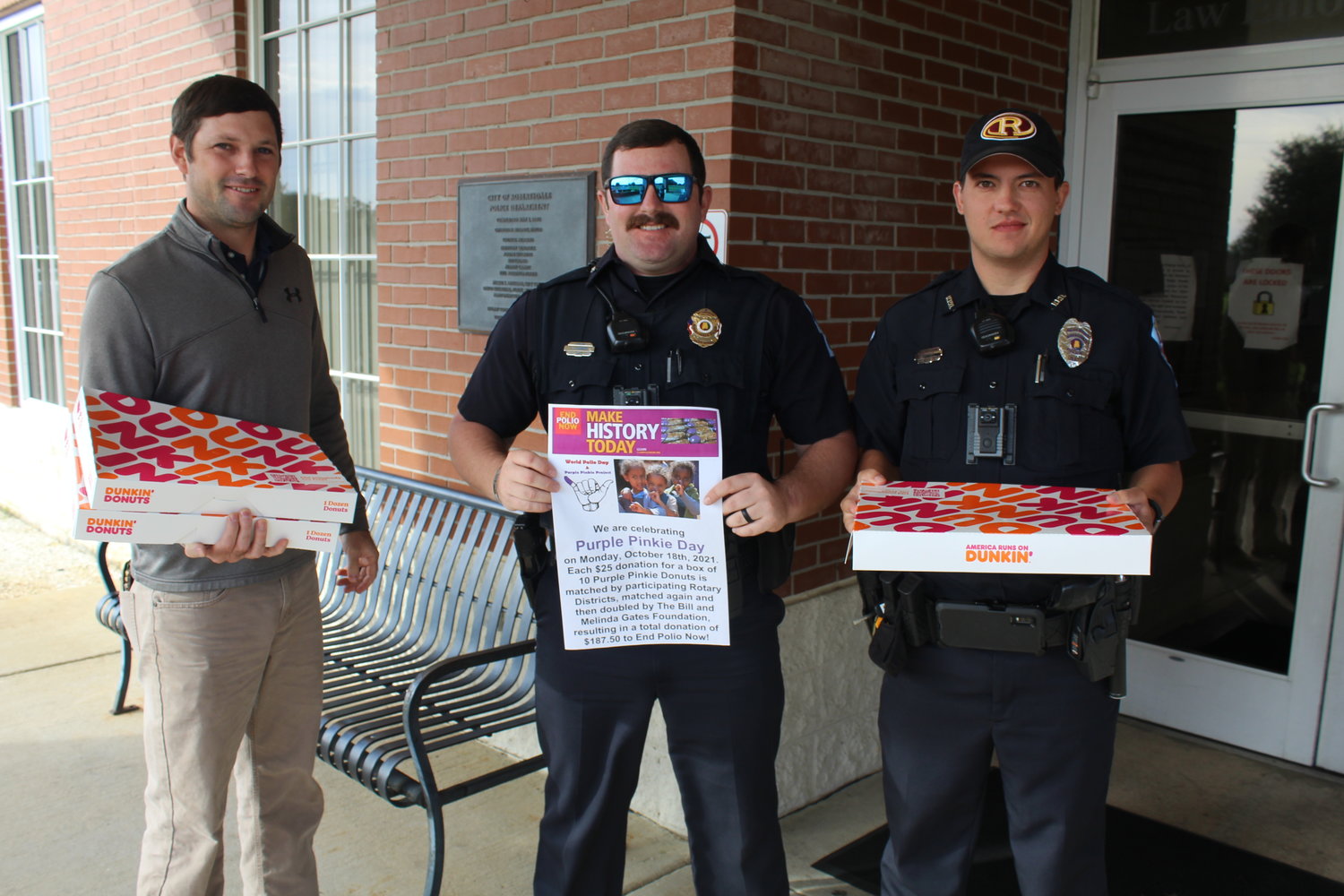 Ryan Frolik, left, Robertsdale Rotary Club vice president/president-elect for 2021-22, delivers Purple Pinkie donuts to the Robertsdale Police Department on Monday, Oct. 18 as part of Purple Pinkie Day for Polio Plus Eradication. Pictured with Frolik are RPD officers Fred Stringer, center, and Zach Williams.