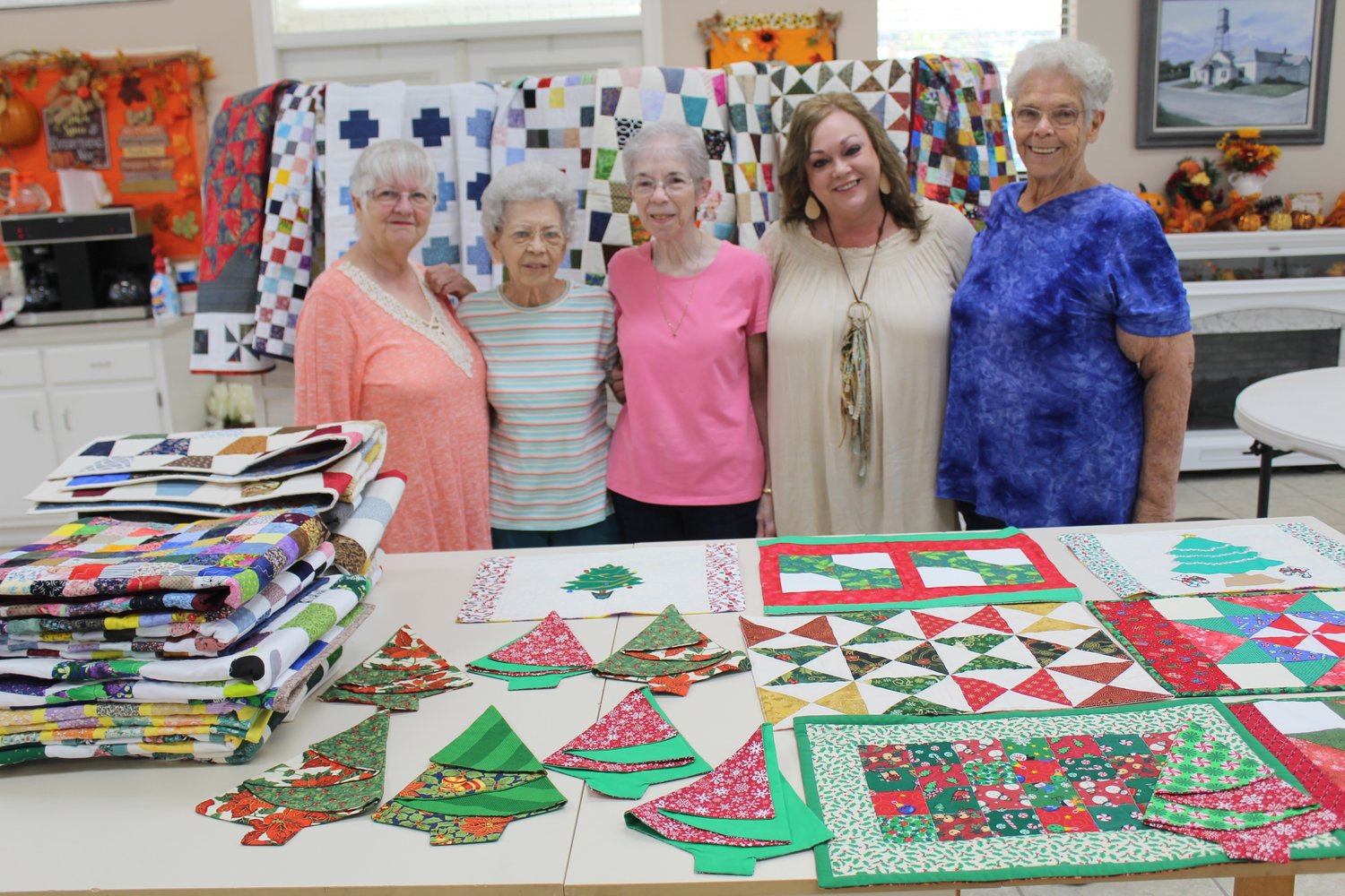 Amy Ochello, senior activities coordinator with the City of Robertsdale, receives a donation of quilts, placemats and napkins from the Sit-N-Sew group of Stitch-N-Friends. Pictured, from left, are Carol Jenks, Bonnie Savell, Pat Hallberg, Ochello and Barbara Landers.