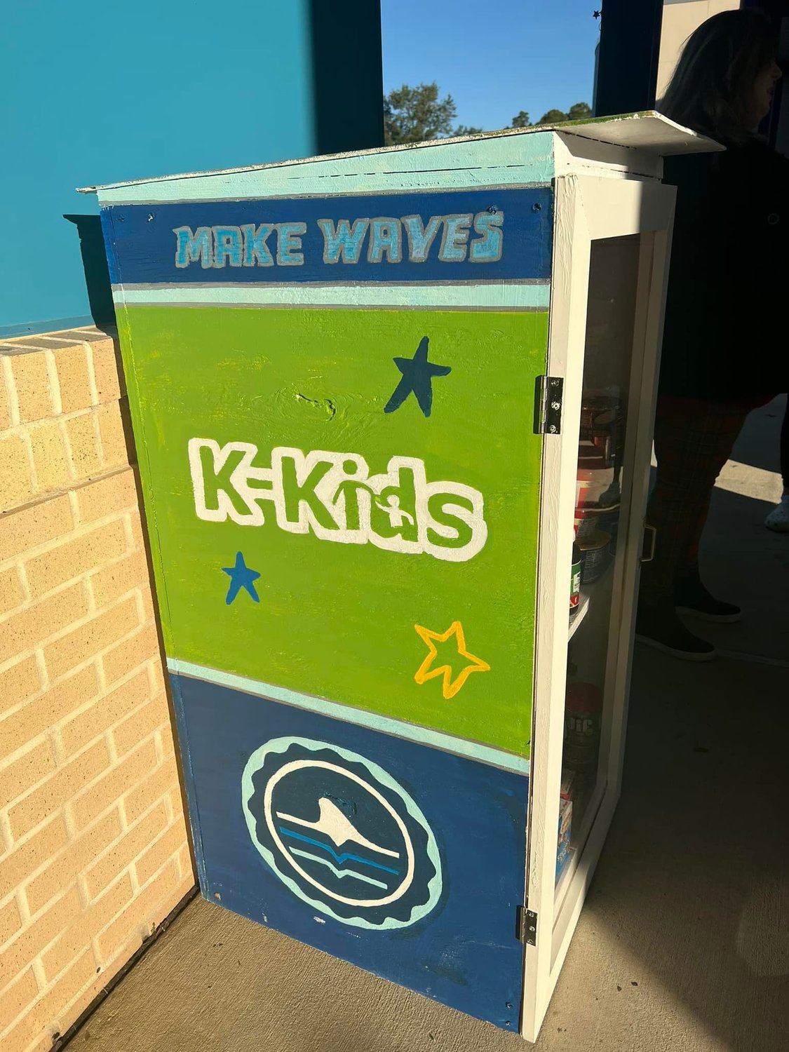 The KKids will check the box and restock daily as needed and anyone in the community can stop by the box to stock it or take what they need.