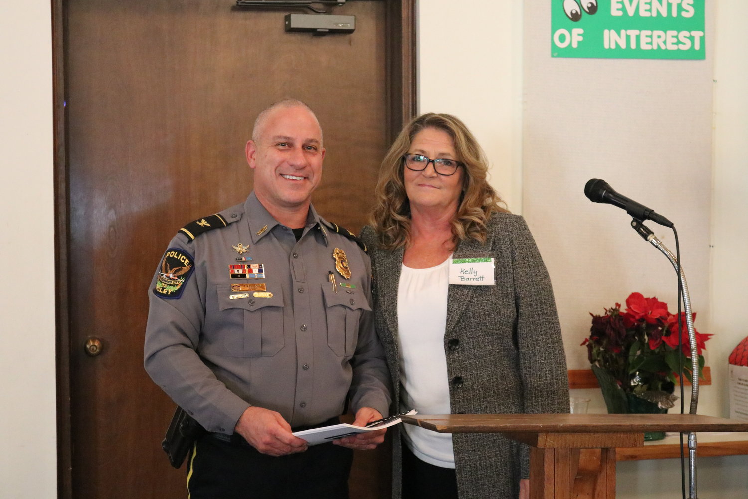 Foley Police Chief Thurston Bullock receives a gift from the club members, presented by Club President Kelly Barrett.