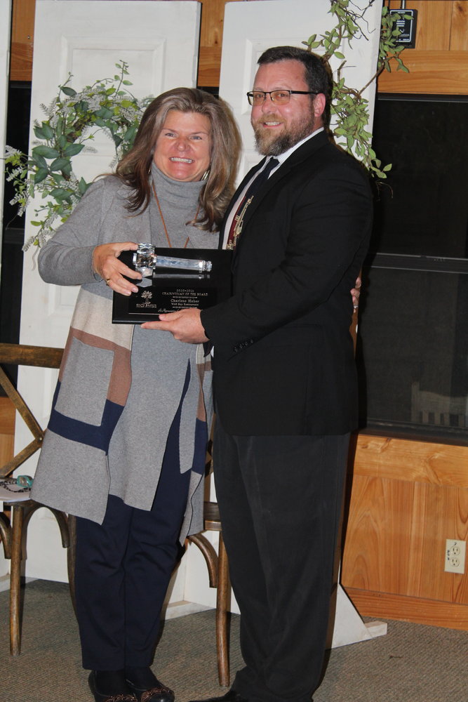 2022 incoming South Baldwin Chamber of Commerce Board Chairman Chad Watkins of WAS Design, Landscape Architects, presents a ceremonial gavel in appreciation to 2020 and 2021 Chairwoman Charlene Haber of Wolf Bay Restaurants.