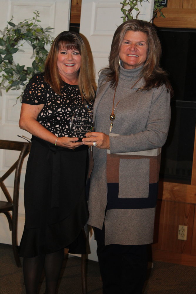 Charlene Haber presents the Volunteer of the Year Award to Belinda Tucker.