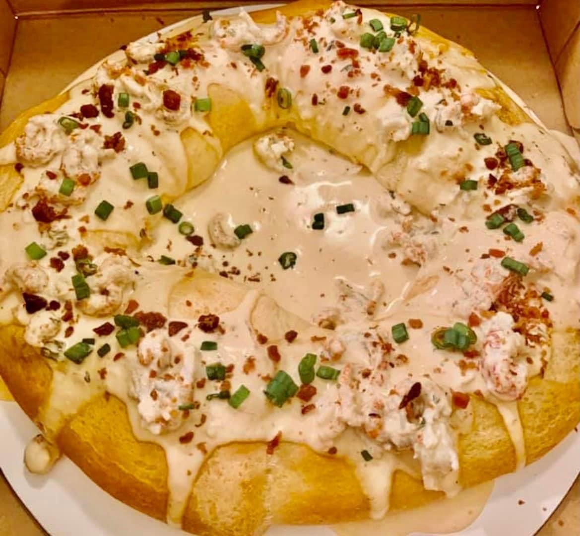 The Crawfish King Cake comes with a creamy crawfish gravy. After warming the King Cake in the oven it is topped with the gravy before being enjoyed. The Crawfish King Cake is $50 and is available for pre-order by calling Gourmet Goodies (251) 239-6325.