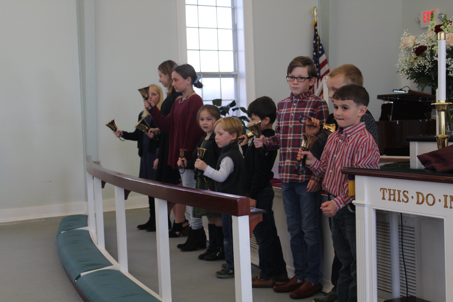 Youth of the Robertsdale United Methodist Church ring bells to open the service celebrating the church’s 100th anniversary.