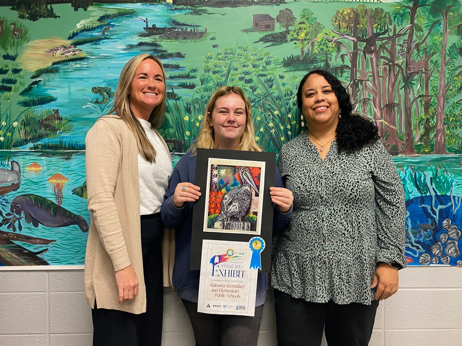 EMS Principal Katy White, Alyssa Morrow, and EMS art teacher Linda Hill. Morrow placed third in the middle school division.