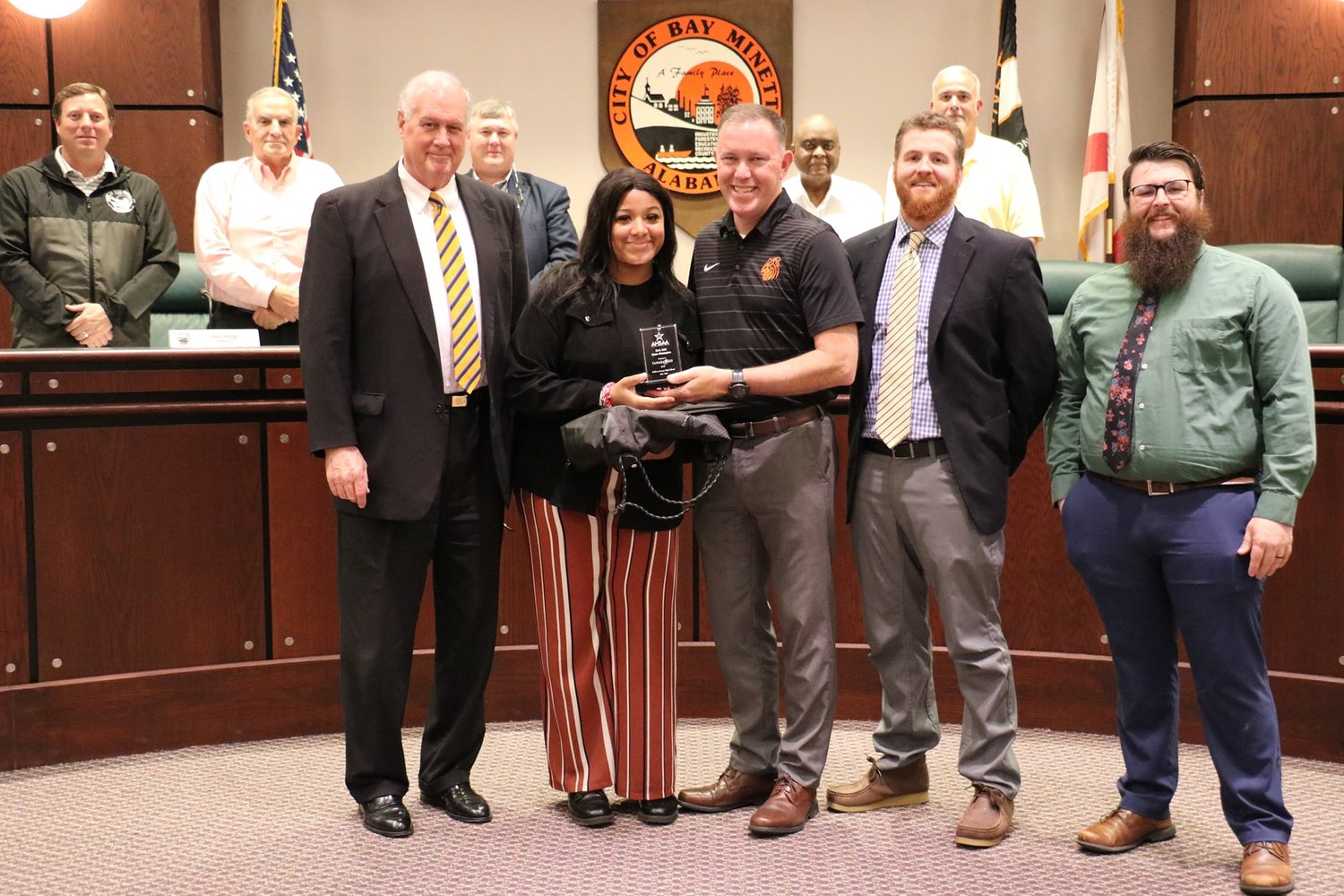 Tamara Reed was honored during a Bay Minette City Council meeting for her many accomplishments this season. Mayor Bob Wills presented her with a special certificate and other gifts, and Baldwin County High School Principal Craig Smith presented her with a state championship award.