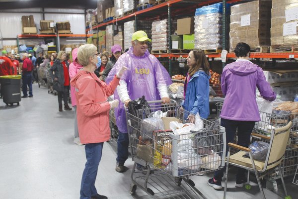 Volunteers at Prodisee Pantry in Spanish Fort prepare for weekly food distribution on Tuesday.