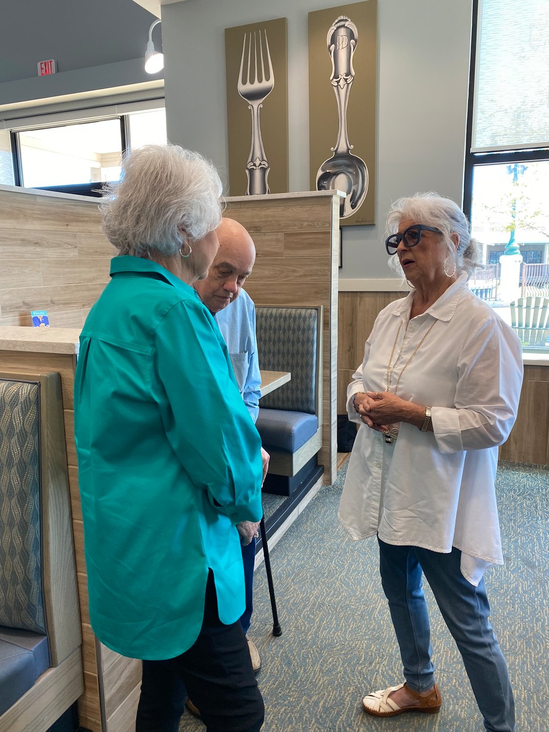 Paula Deen speaks with Linda and Dallas Brooks. Linda Brooks is vice-chair of the Creek Indian Enterprises Development Authority.